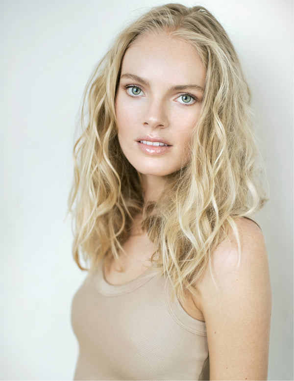 Soft studio portrait of a blonde woman in a nude top, New York portrait session