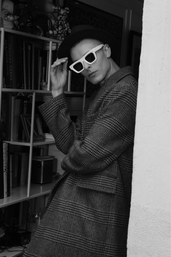 Black and white fashion portrait of a man in sunglasses and a long coat, editorial portrait NYC