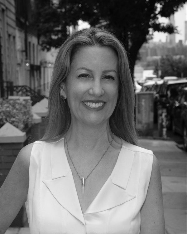 Black and white portrait of a smiling woman on a city street, outdoor portrait session in New York