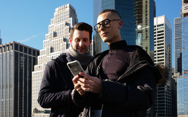 Couple taking a selfie among Financial District skyscrapers, NYC couples session by Lena Di
