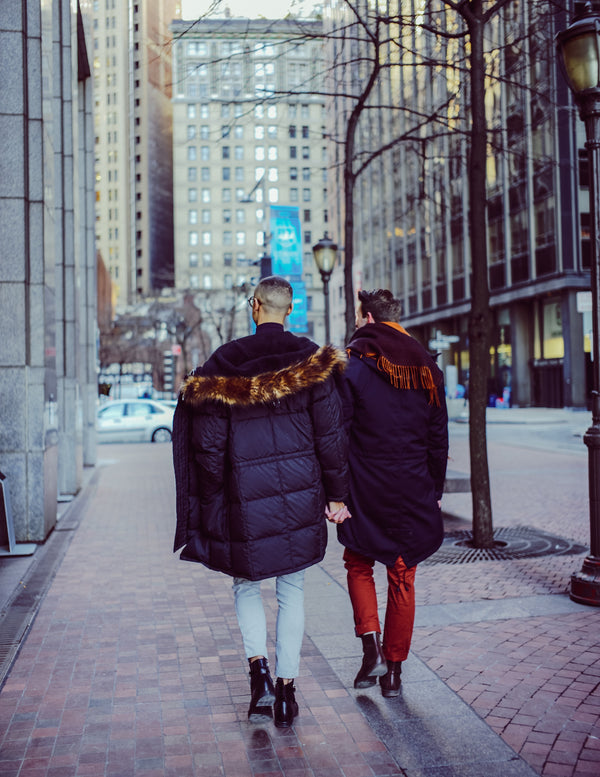 Couple walking hand in hand down a Financial District street, NYC couples session by Lena Di