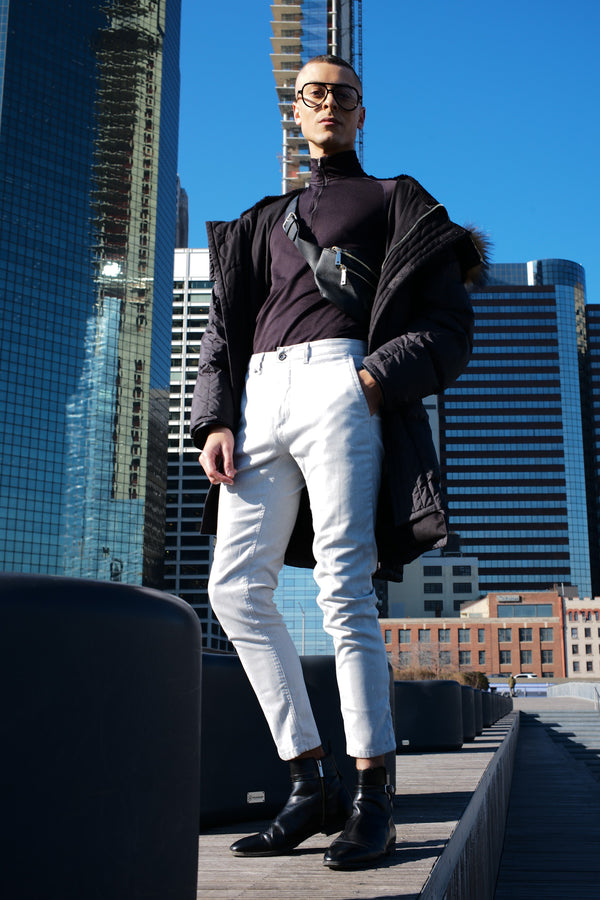 Man in sunglasses and white trousers on a Manhattan rooftop among skyscrapers, NYC portrait photographer Lena Di