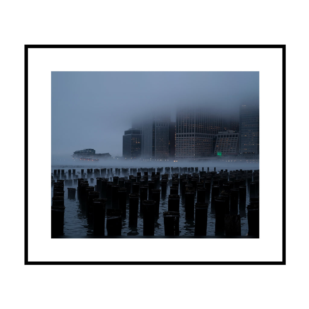 Gotham in the Fog, color Manhattan skyline in fog above old pier pilings fine art photography print by Lena Di, shown framed with a white mat