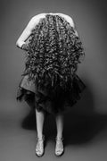 Flipped out, black and white woman bent forward with long curly hair covering her face fine art photography print by Lena Di