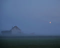 House Under a Red Moon, color farmhouse in blue fog under a small red moon fine art photography print by Lena Di