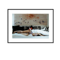Hungry Sofa Color, color woman lying on a sofa beneath an abstract painting fine art photography print by Lena Di, shown framed with a white mat