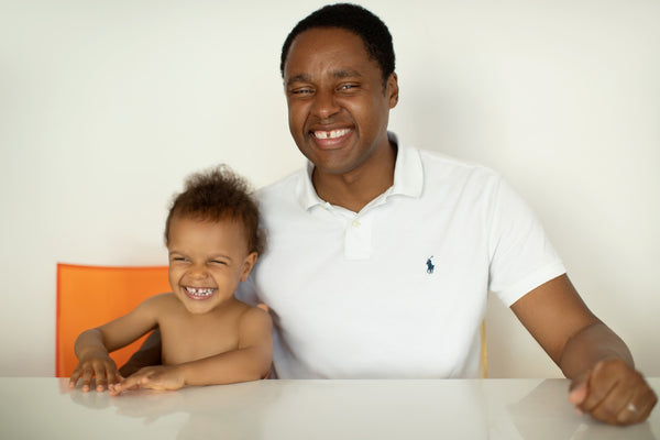 Family portrait of a father with his toddler son at the table, NYC family photographer Lena Di