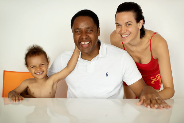 Family portrait of mother, father and toddler son at home, NYC family photographer Lena Di