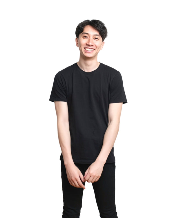 Actor headshot on white, smiling three-quarter portrait in a black tee, NYC actor headshot photographer Lena Di