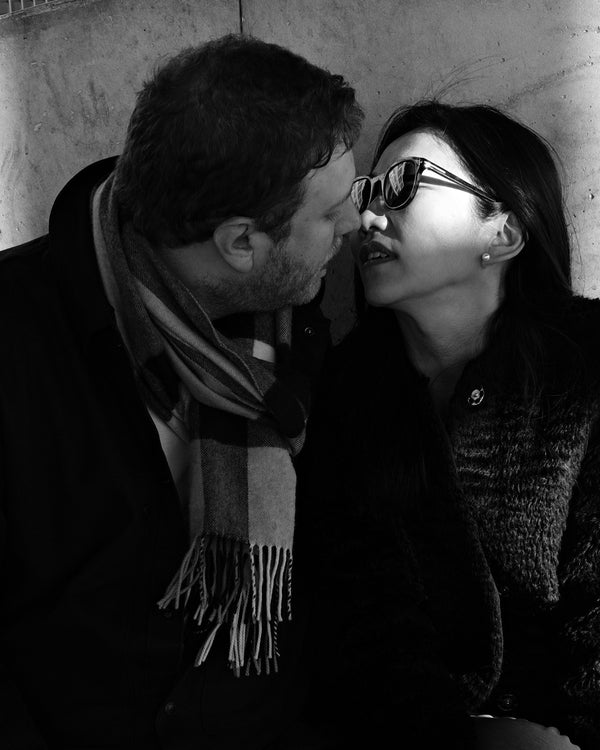 Couple about to kiss in a plaid scarf and sunglasses, black and white NYC engagement portrait