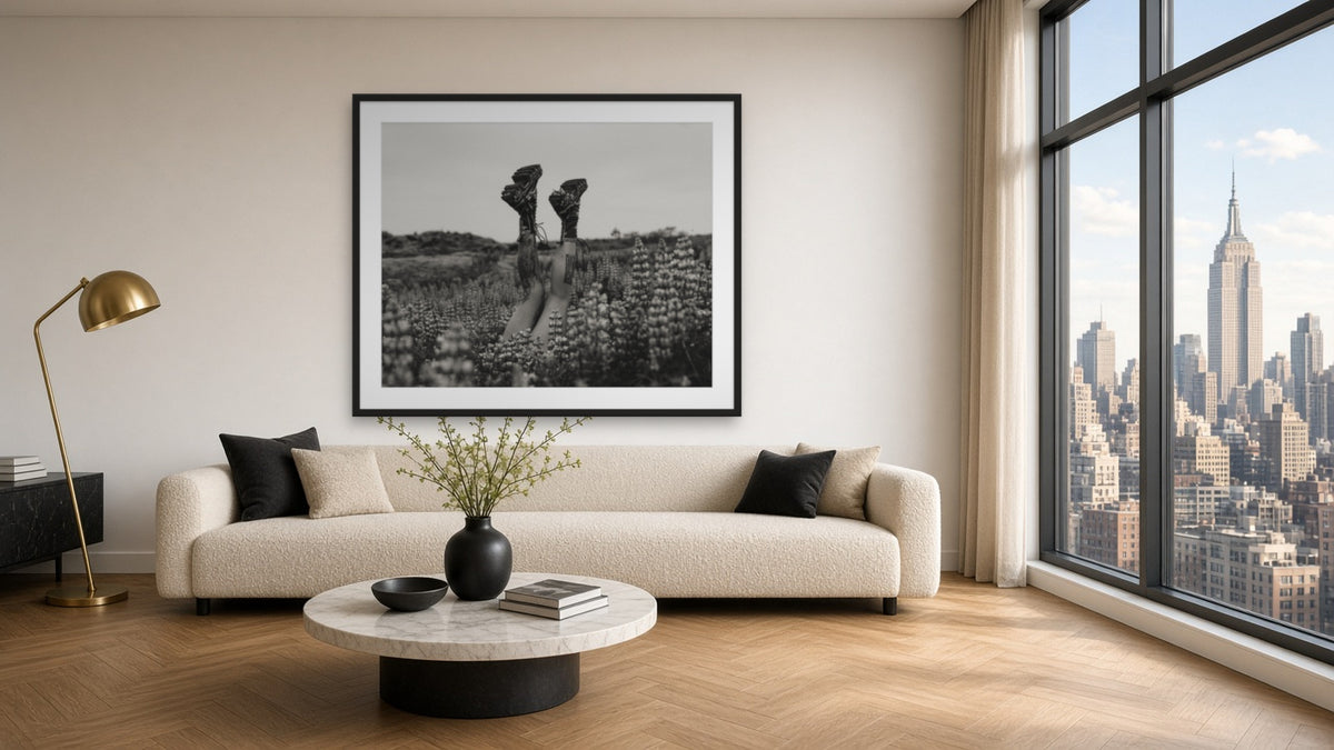 The boots in Grass by Lena Di, fine art photography print in a black frame